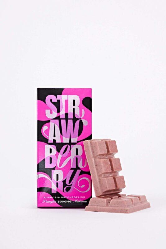 Euphoria Psychedelics Strawberry Swirl 6000mg packaging with a pink and black design, featuring a chocolate bar piece.